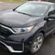 A photo of a black Honda CR-V SUV stopped in a parking lot